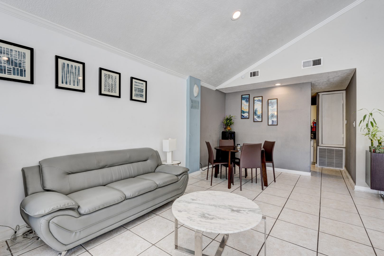 a living room with a couch, coffee table and a television at The Caldera Apartments