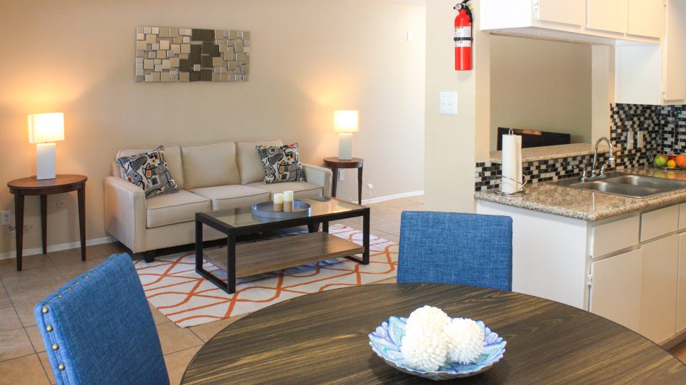 a kitchen and living room with a table and chairs at The Caldera Apartments