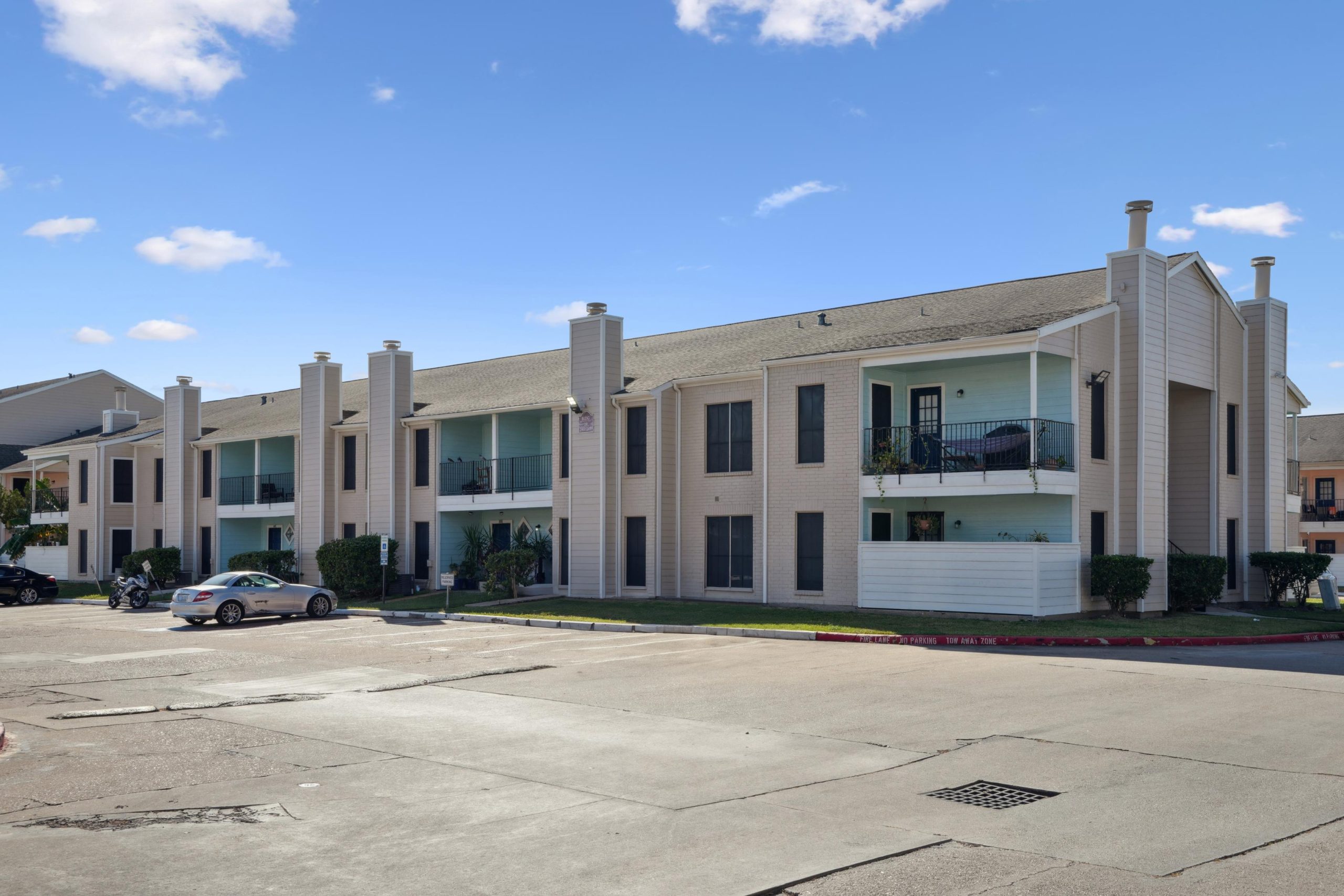 a large white building with a white building behind it