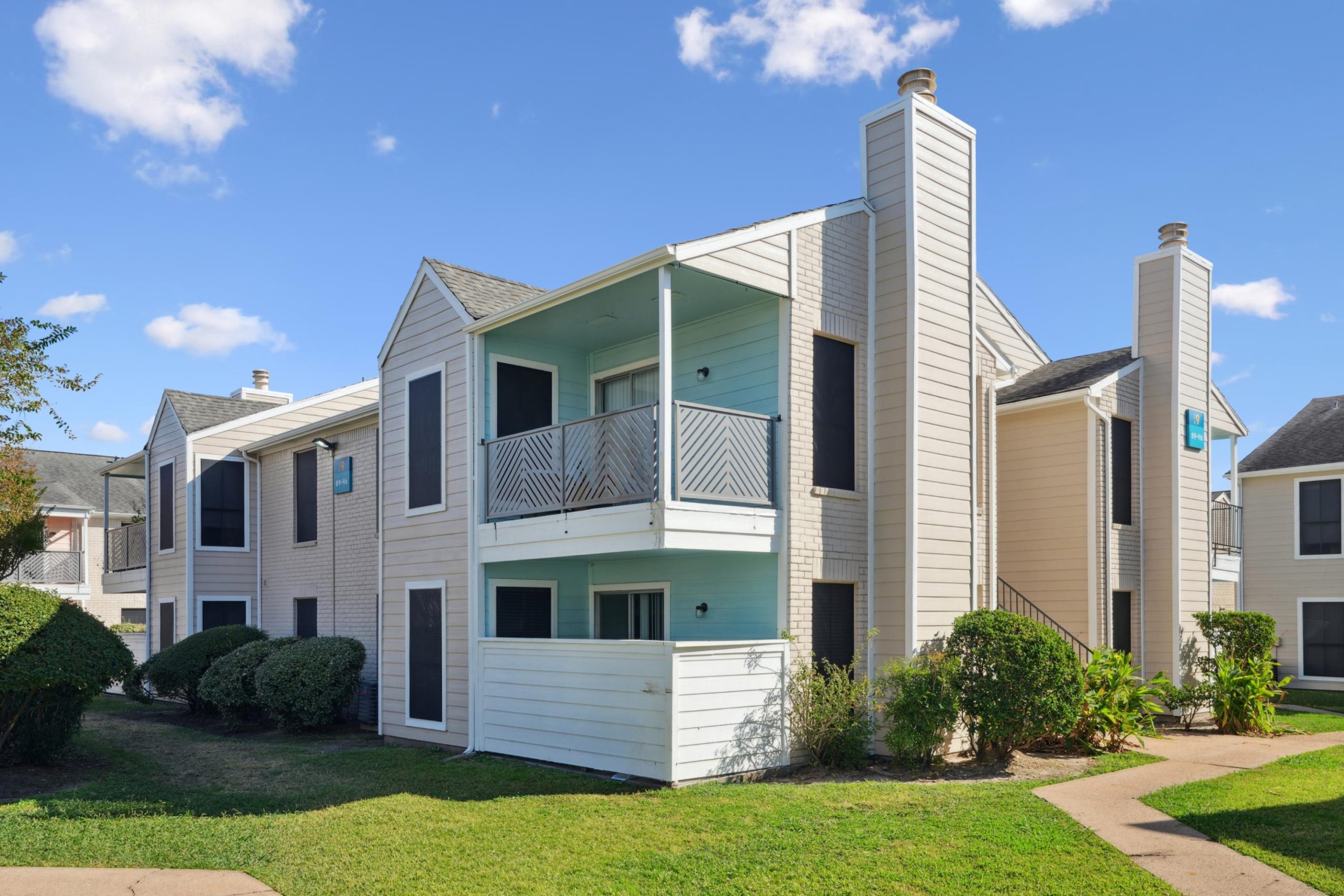 a white house sitting in front of a house