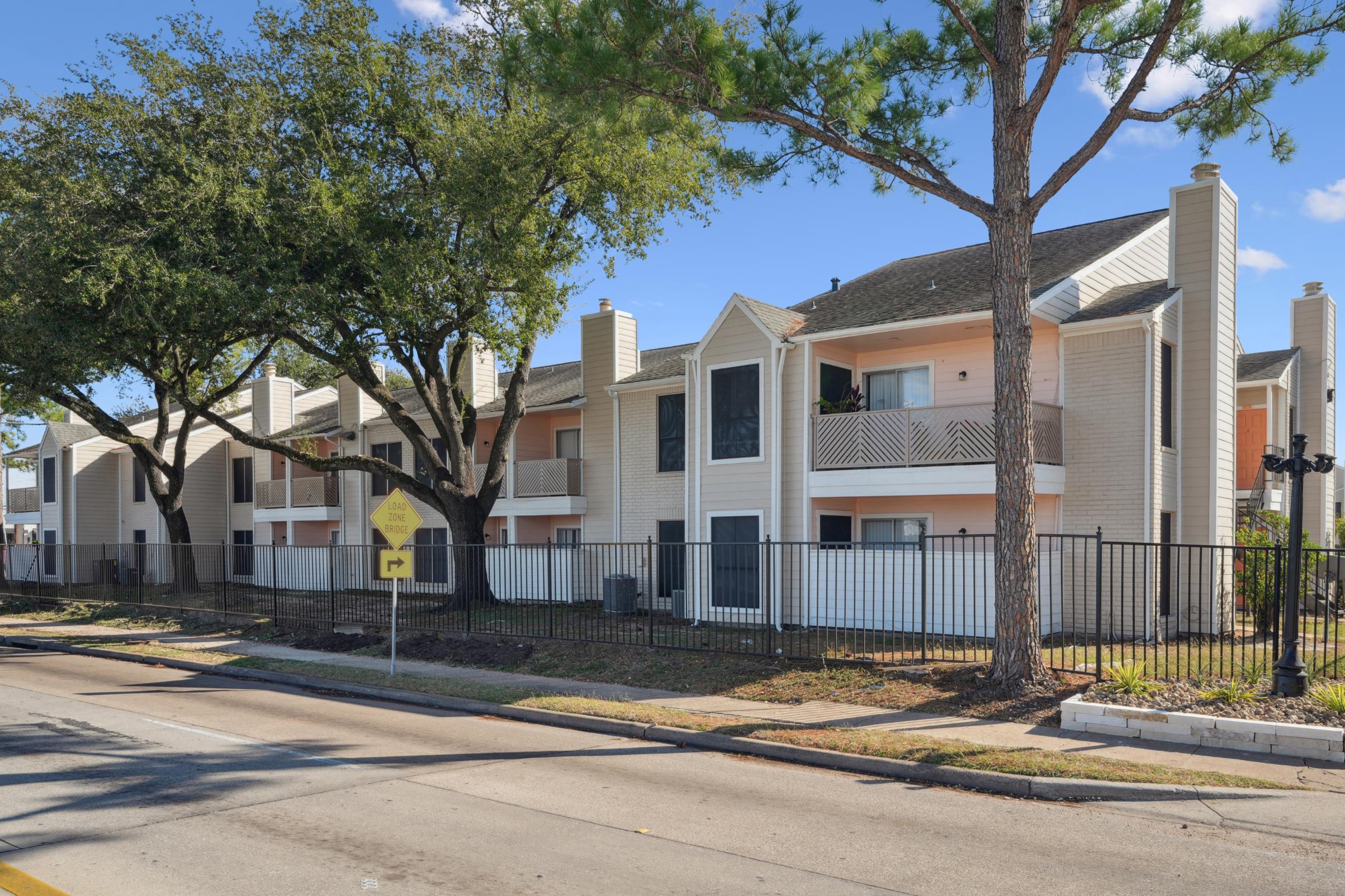 a white house sitting in front of a house