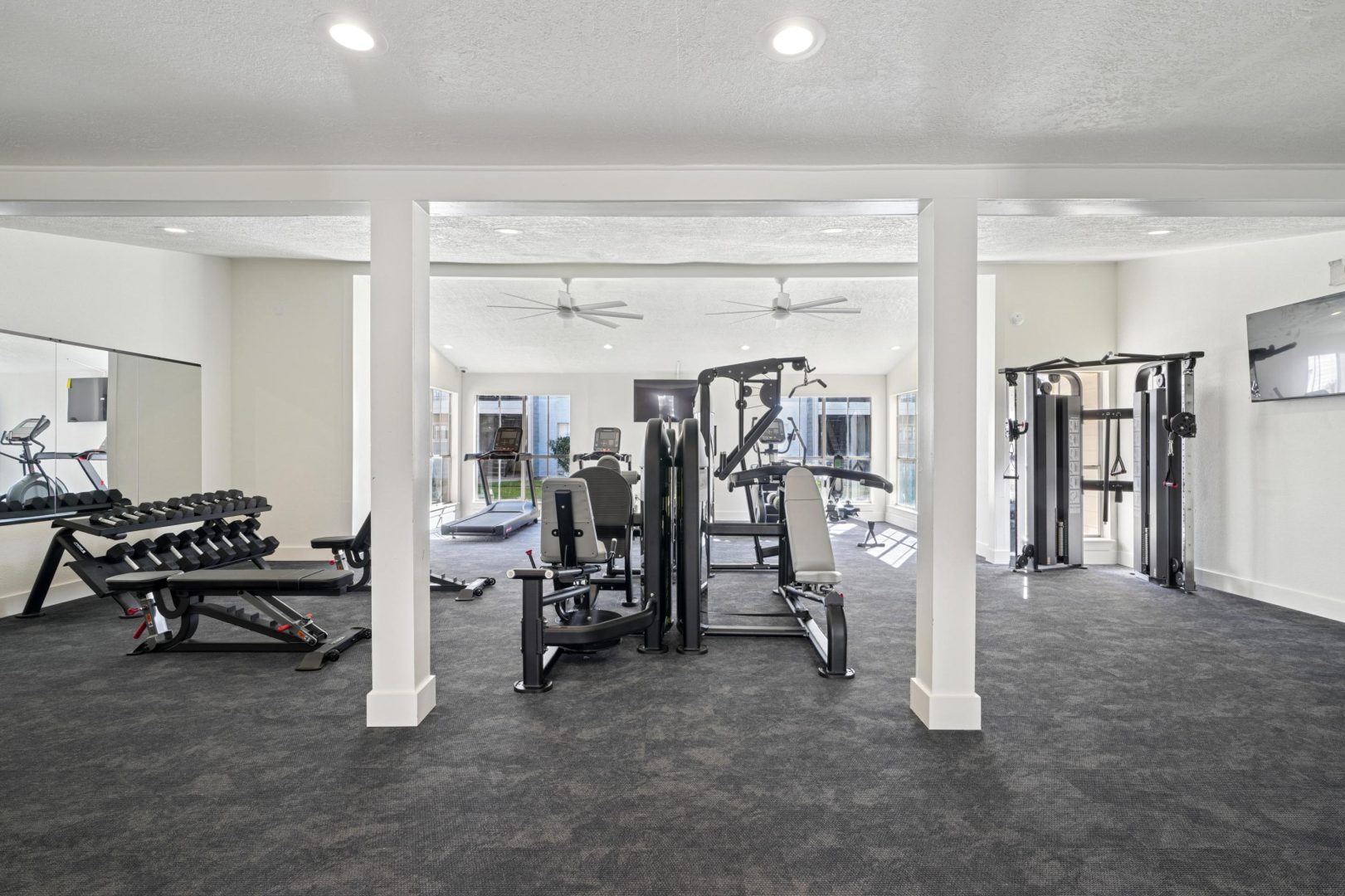 a room with a chair, a table, and a tv