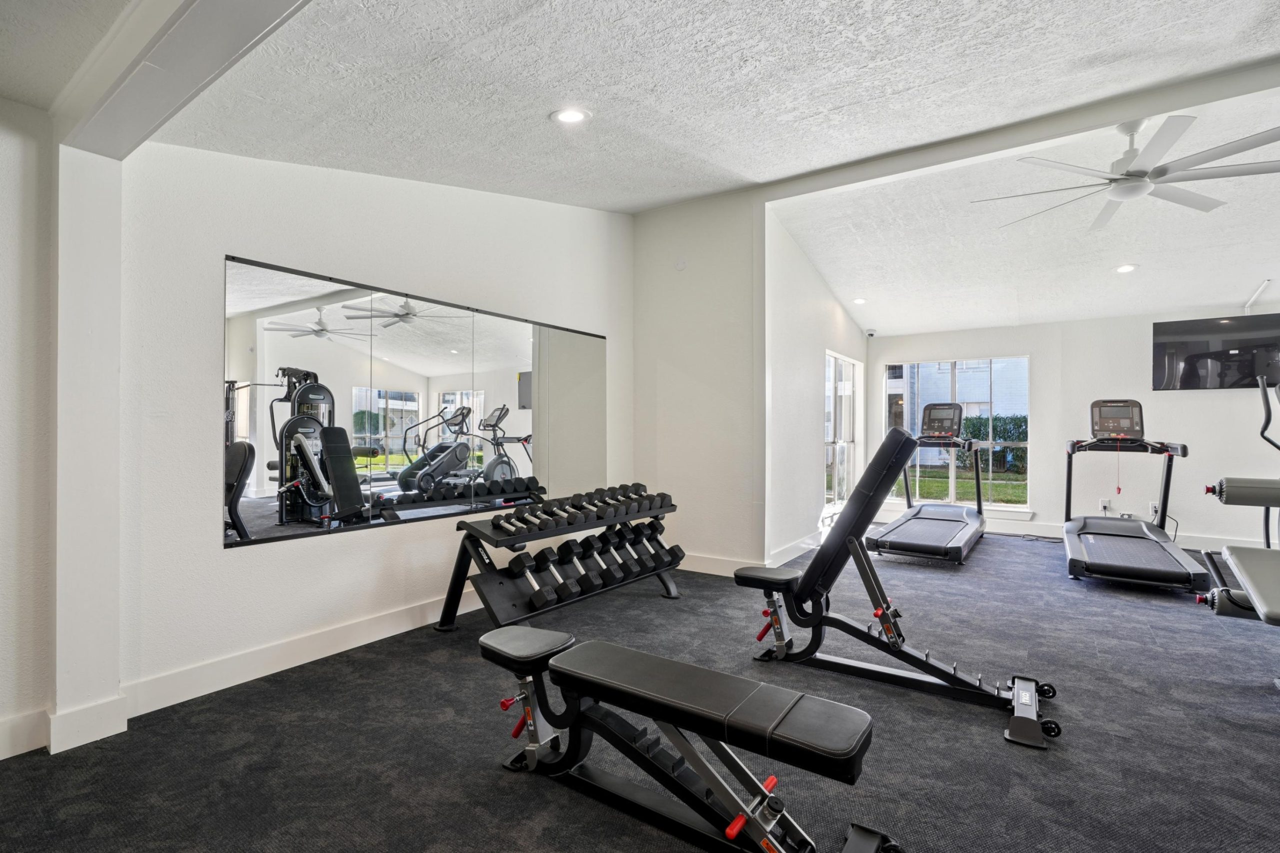 a living room with a bench and a large window