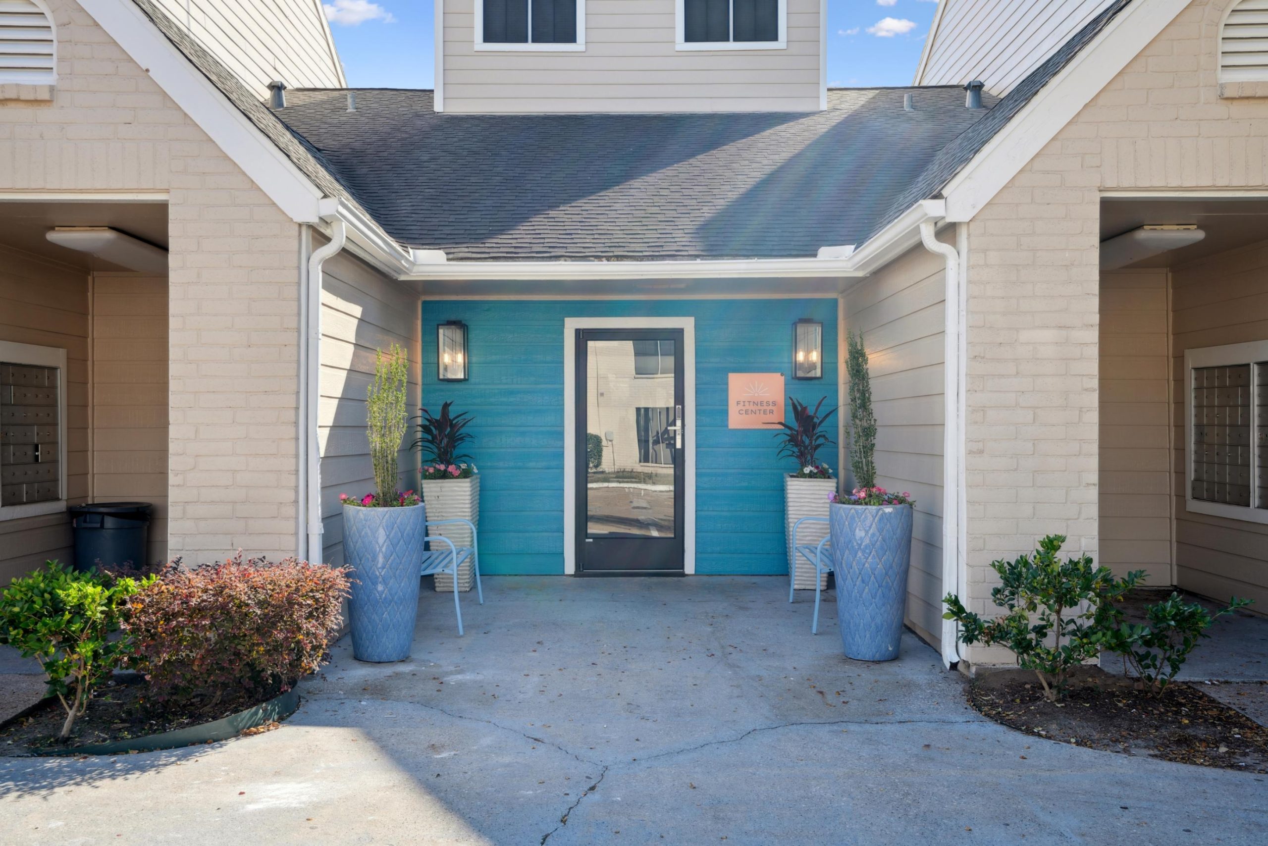 a house with a blue door and a white refrigerator